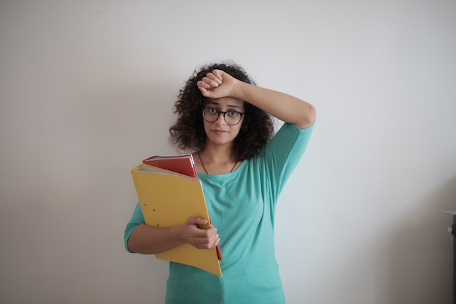 Photo by Andrea Piacquadio: https://www.pexels.com/photo/tired-adult-woman-with-papers-in-light-modern-office-3808818/