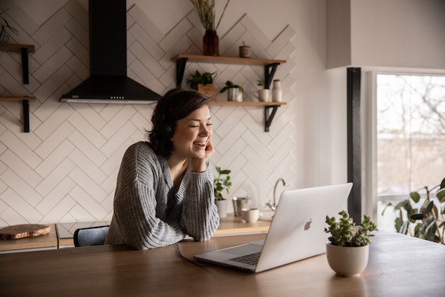 work from home, Photo by EKATERINA BOLOVTSOVA: https://www.pexels.com/photo/smiling-woman-talking-via-laptop-in-kitchen-4049992/