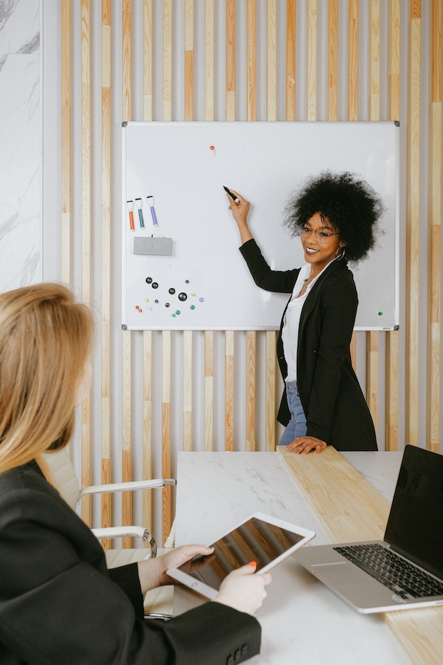 Photo by Anna Shvets: https://www.pexels.com/photo/woman-pointing-at-whiteboard-3727511/, coaching