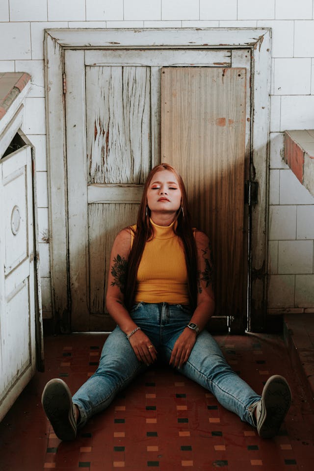 Girl sitting on the floor tired after scavenging junk removal for resellers business