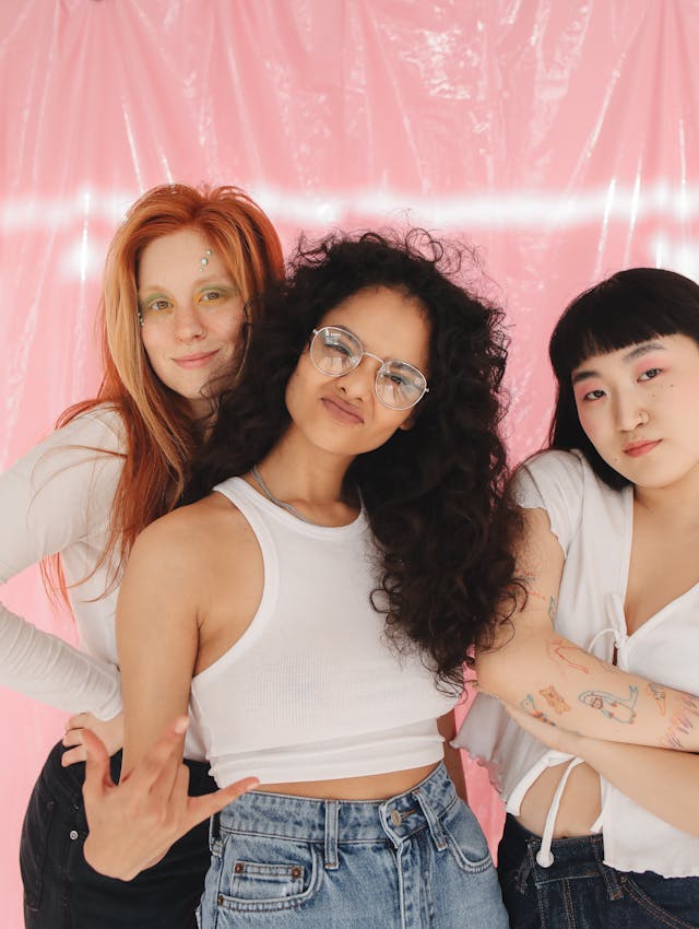 3 diverse women posing in front of the camera.