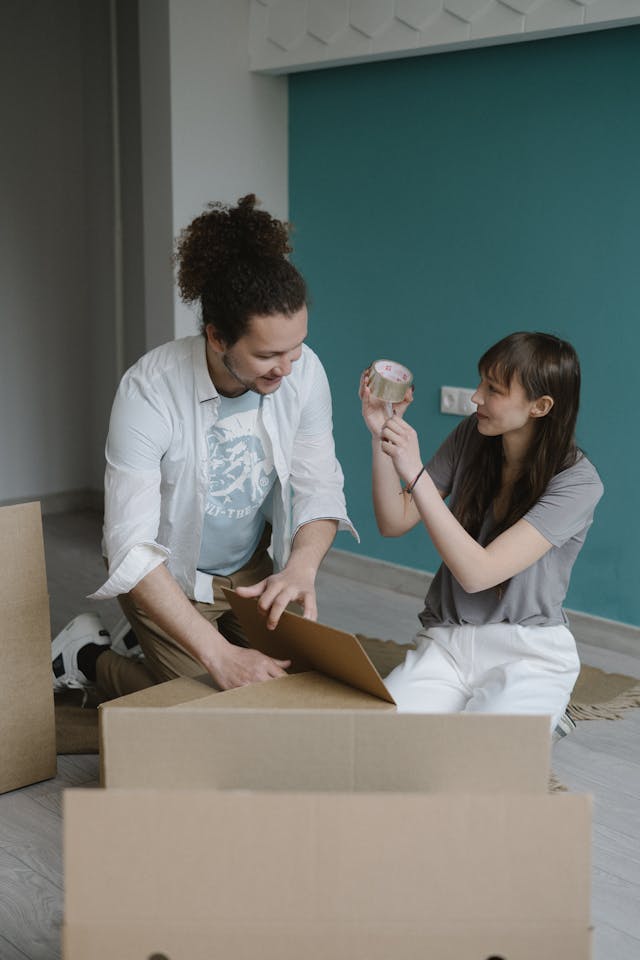 couple working on boxing for their ebay store