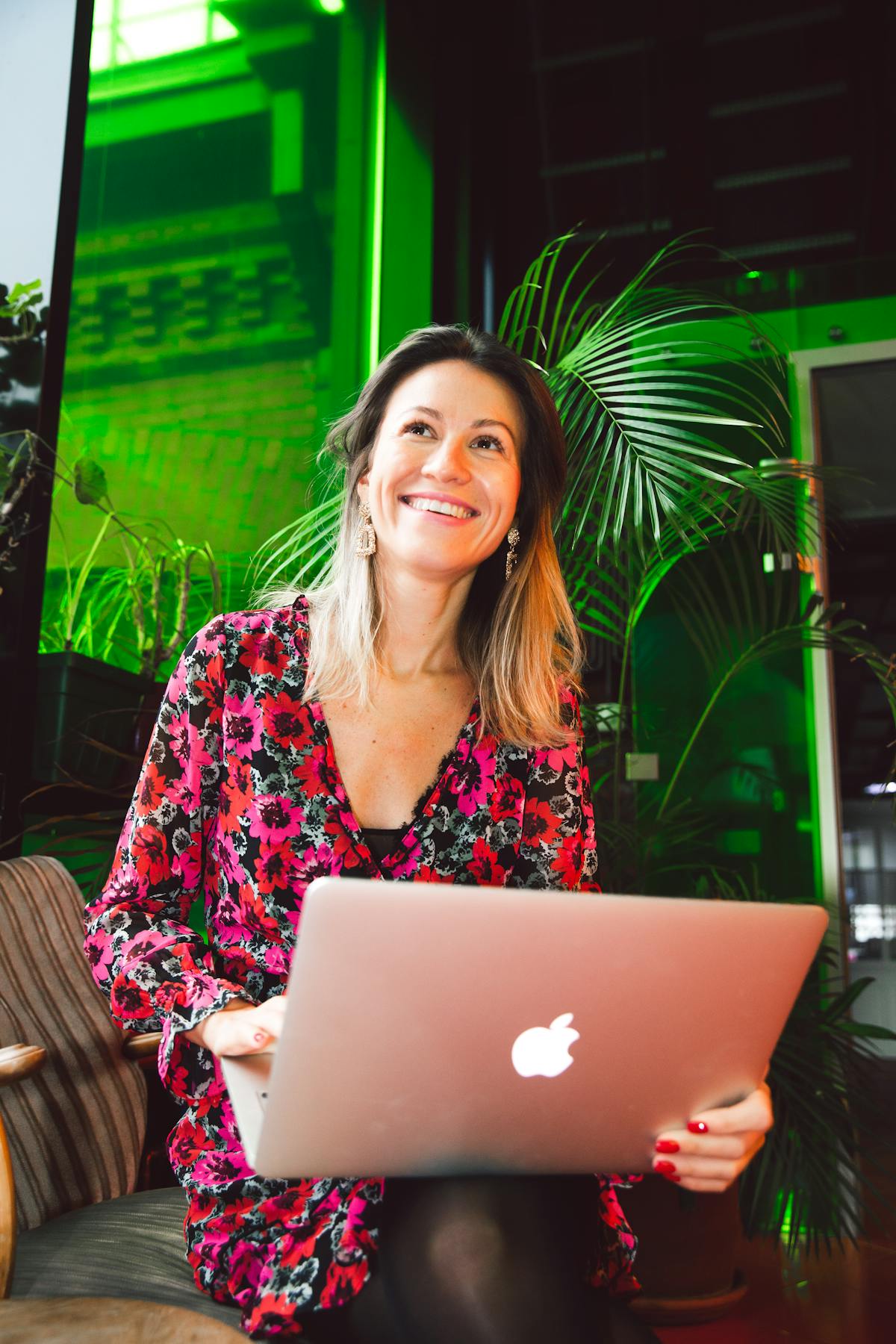 Lady with Apple laptop smiling from selling from her Poshmark Closet.